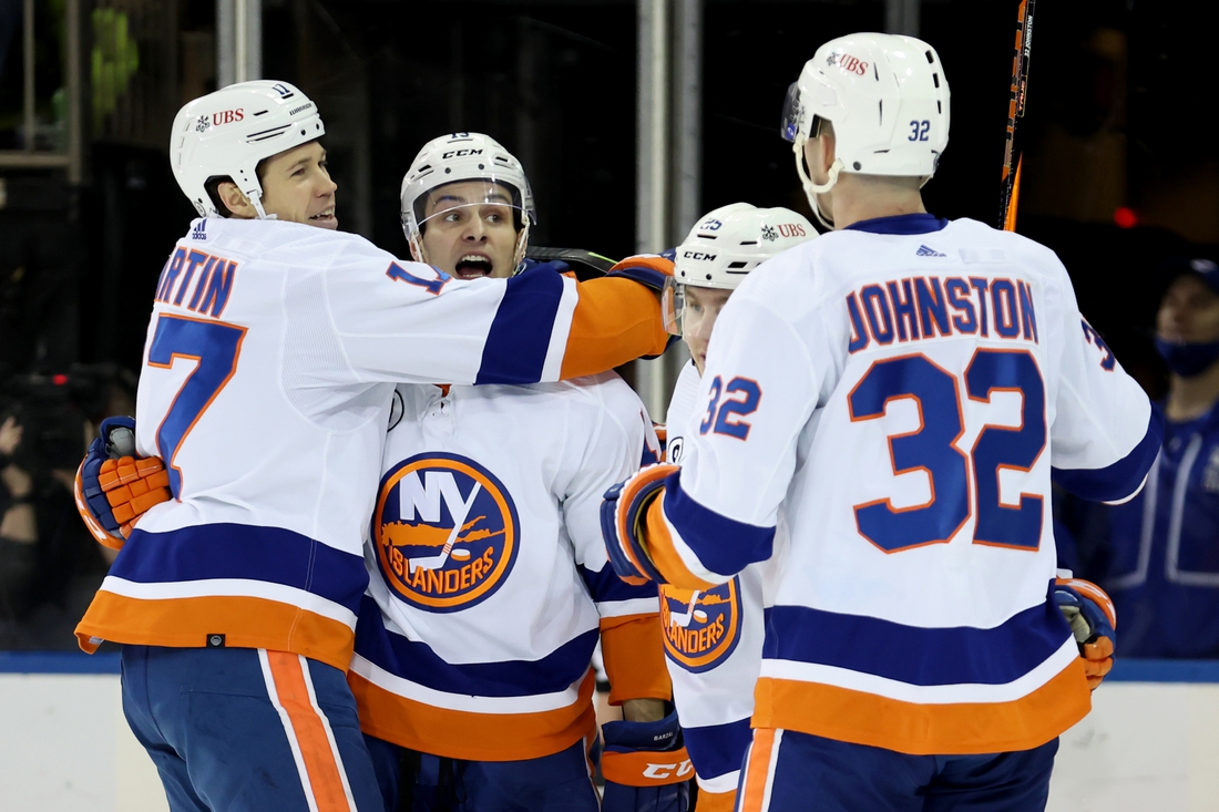 Apr 1, 2022; New York, New York, USA; New York Islanders left wing Matt Martin (17) celebrates his goal against the New York Rangers with center Mathew Barzal (13) and defenseman Sebastian Aho (25) and left wing Ross Johnston (32) during the second period at Madison Square Garden. Mandatory Credit: Brad Penner-USA TODAY Sports