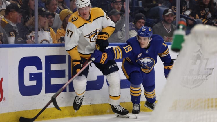 Apr 1, 2022; Buffalo, New York, USA;  Nashville Predators right wing Michael McCarron (47) and Buffalo Sabres center Peyton Krebs (19) go after a loose puck during the second period at KeyBank Center. Mandatory Credit: Timothy T. Ludwig-USA TODAY Sports
