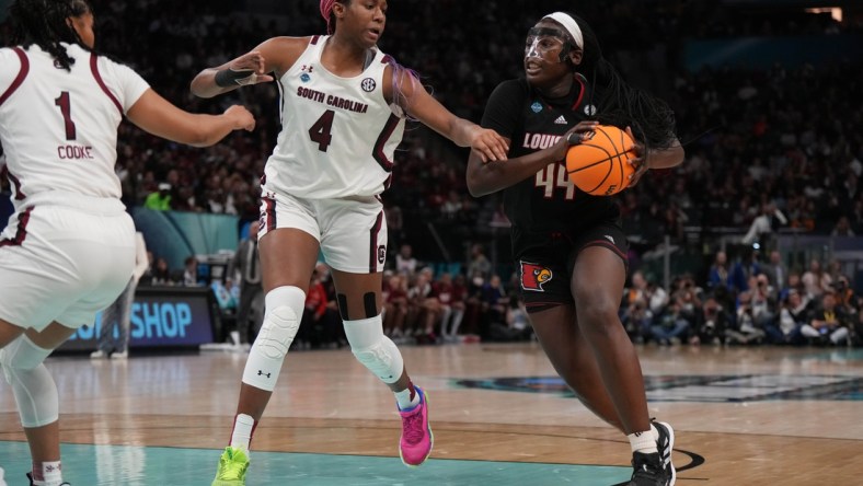 Apr 1, 2022; Minneapolis, MN, USA; Louisville Cardinals forward Olivia Cochran (44) controls the ball as South Carolina Gamecocks forward Aliyah Boston (4) defends in the second half in the Final Four semifinals of the women's college basketball NCAA Tournament at Target Center. Mandatory Credit: Kirby Lee-USA TODAY Sports