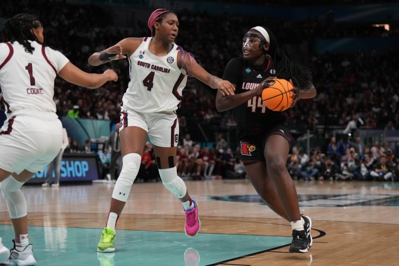 Apr 1, 2022; Minneapolis, MN, USA; Louisville Cardinals forward Olivia Cochran (44) controls the ball as South Carolina Gamecocks forward Aliyah Boston (4) defends in the second half in the Final Four semifinals of the women's college basketball NCAA Tournament at Target Center. Mandatory Credit: Kirby Lee-USA TODAY Sports