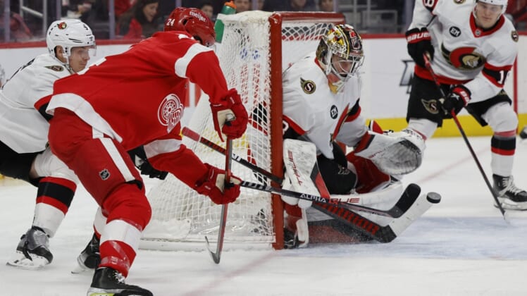 Apr 1, 2022; Detroit, Michigan, USA;  Ottawa Senators goaltender Mads Sogaard (33) makes a save on Detroit Red Wings center Pius Suter (24) in the second period at Little Caesars Arena. Mandatory Credit: Rick Osentoski-USA TODAY Sports