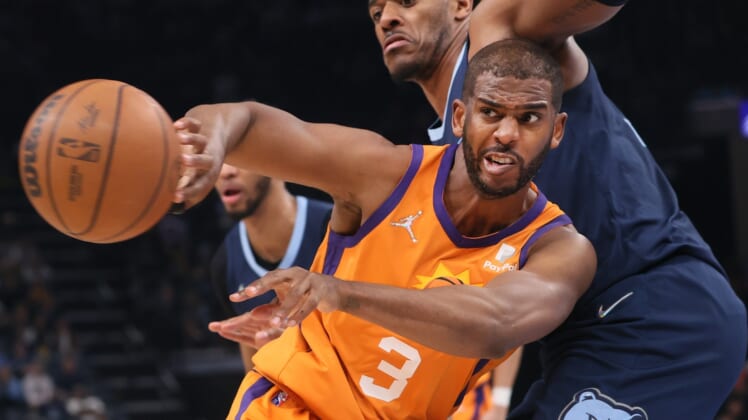 Apr 1, 2022; Memphis, Tennessee, USA; Phoenix Suns guard Chris Paul (3) passes the ball as Memphis Grizzlies center Xavier Tillman (2) defends at FedExForum. Mandatory Credit: Joe Rondone-USA TODAY Sports