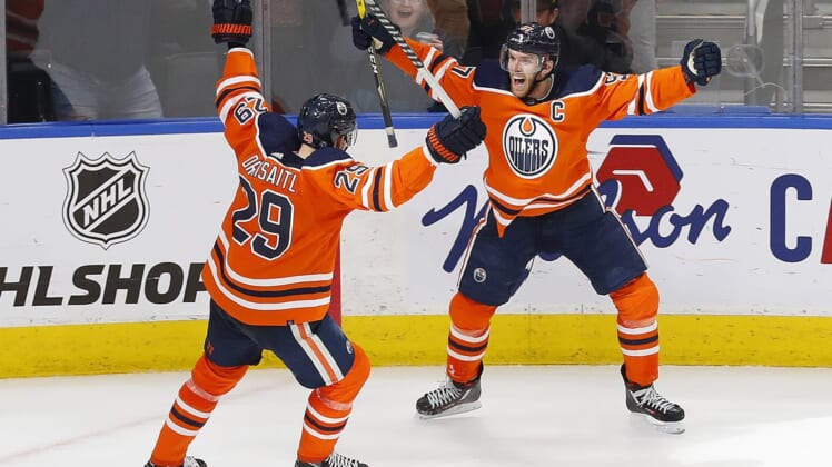 Apr 1, 2022; Edmonton, Alberta, CAN; Edmonton Oilers forward Connor McDavid (97) celebrates an overtime winning goal with center Leon Draisaitl (29) against the St. Louis Blues at Rogers Place. Mandatory Credit: Perry Nelson-USA TODAY Sports