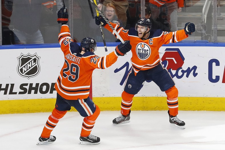 Apr 1, 2022; Edmonton, Alberta, CAN; Edmonton Oilers forward Connor McDavid (97) celebrates an overtime winning goal with center Leon Draisaitl (29) against the St. Louis Blues at Rogers Place. Mandatory Credit: Perry Nelson-USA TODAY Sports