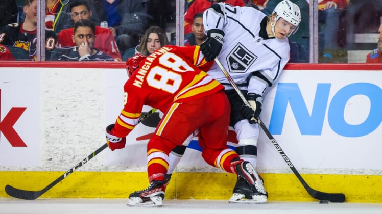 Mar 31, 2022; Calgary, Alberta, CAN; Los Angeles Kings center Lias Andersson (17) and Calgary Flames left wing Andrew Mangiapane (88) battle for the puck during the second period at Scotiabank Saddledome. Mandatory Credit: Sergei Belski-USA TODAY Sports