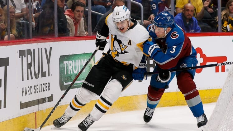 Apr 2, 2022; Denver, Colorado, USA; Pittsburgh Penguins center Evgeni Malkin (71) and Colorado Avalanche defenseman Jack Johnson (3) battle for the puck in the first period at Ball Arena. Mandatory Credit: Isaiah J. Downing-USA TODAY Sports