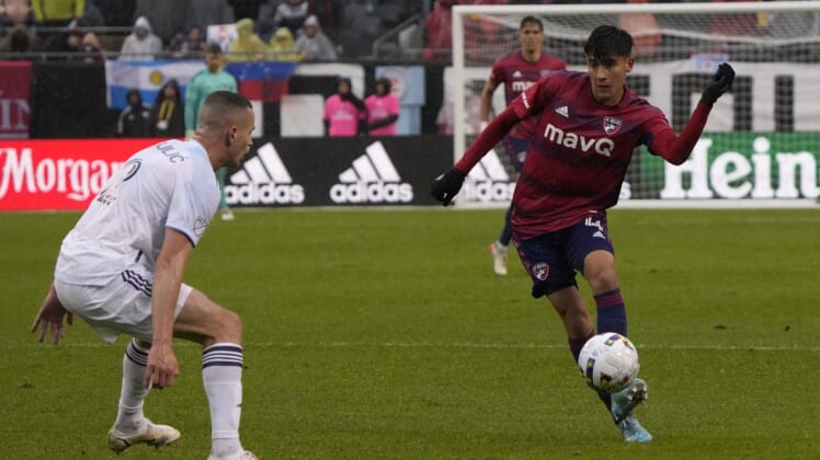 Apr 2, 2022; Chicago, Illinois, USA; FC Dallas defender Marco Farfan (4) makes a pass on Chicago Fire defender Boris Sekulic (2) during the first half at Soldier Field. Mandatory Credit: Mike Dinovo-USA TODAY Sports