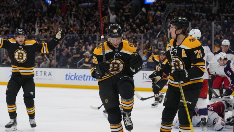 Apr 2, 2022; Boston, Massachusetts, USA; Boston Bruins left wing Erik Haula (56) reacts to scoring a goal along with Boston Bruins defenseman Charlie McAvoy (73) against the Columbus Blue Jackets during the first period at TD Garden. Mandatory Credit: Gregory Fisher-USA TODAY Sports