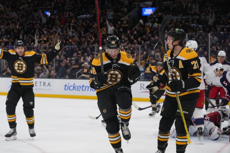 Apr 2, 2022; Boston, Massachusetts, USA; Boston Bruins left wing Erik Haula (56) reacts to scoring a goal along with Boston Bruins defenseman Charlie McAvoy (73) against the Columbus Blue Jackets during the first period at TD Garden. Mandatory Credit: Gregory Fisher-USA TODAY Sports