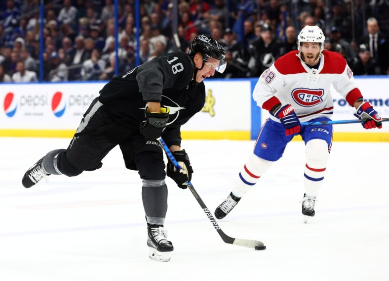 Apr 2, 2022; Tampa, Florida, USA; Tampa Bay Lightning left wing Ondrej Palat (18) skates with the puck as Montreal Canadiens center Mike Hoffman (68) defends during the first period at Amalie Arena. Mandatory Credit: Kim Klement-USA TODAY Sports