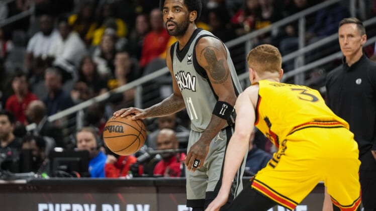 Apr 2, 2022; Atlanta, Georgia, USA; Brooklyn Nets guard Kyrie Irving (11) dribbles guarded by Atlanta Hawks guard Kevin Huerter (3) during the first half at State Farm Arena. Mandatory Credit: Dale Zanine-USA TODAY Sports