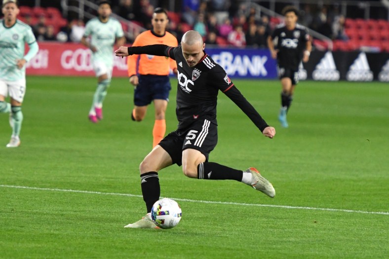 Apr 2, 2022; Washington, District of Columbia, USA;  D.C. United defender Brad Smith (5) takes a shot in the first half against the Atlanta United at Audi Field. Mandatory Credit: Mitchell Layton-USA TODAY Sports