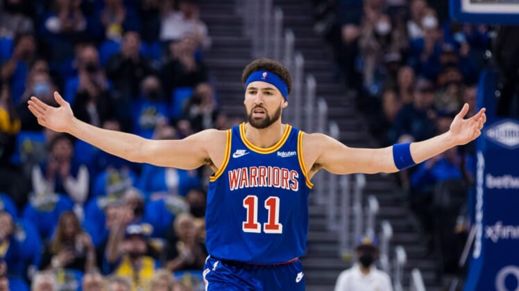 Apr 2, 2022; San Francisco, California, USA;  Golden State Warriors guard Klay Thompson (11) reacts after scoring on a three-point shot against the Utah Jazz during the first half at Chase Center. Mandatory Credit: John Hefti-USA TODAY Sports