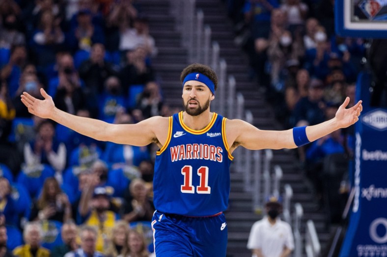 Apr 2, 2022; San Francisco, California, USA;  Golden State Warriors guard Klay Thompson (11) reacts after scoring on a three-point shot against the Utah Jazz during the first half at Chase Center. Mandatory Credit: John Hefti-USA TODAY Sports