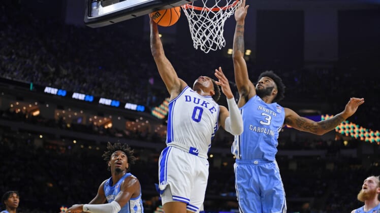 Apr 2, 2022; New Orleans, LA, USA; Duke Blue Devils forward Wendell Moore Jr. (0) misses his shot against North Carolina Tar Heels guard Dontrez Styles (3) during the first half during the 2022 NCAA men's basketball tournament Final Four semifinals at Caesars Superdome. Mandatory Credit: Bob Donnan-USA TODAY Sports