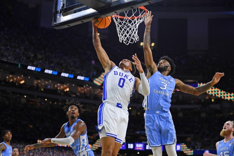 Apr 2, 2022; New Orleans, LA, USA; Duke Blue Devils forward Wendell Moore Jr. (0) misses his shot against North Carolina Tar Heels guard Dontrez Styles (3) during the first half during the 2022 NCAA men's basketball tournament Final Four semifinals at Caesars Superdome. Mandatory Credit: Bob Donnan-USA TODAY Sports
