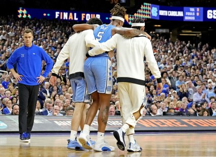 Apr 2, 2022; New Orleans, LA, USA; North Carolina Tar Heels forward Armando Bacot (5) is help off the court during the second half against the Duke Blue Devils in the 2022 NCAA men's basketball tournament Final Four semifinals at Caesars Superdome. Mandatory Credit: Robert Deutsch-USA TODAY Sports