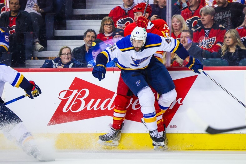 Apr 2, 2022; Calgary, Alberta, CAN; St. Louis Blues defenseman Robert Bortuzzo (41) and Calgary Flames left wing Milan Lucic (17) collide during the first period at Scotiabank Saddledome. Mandatory Credit: Sergei Belski-USA TODAY Sports