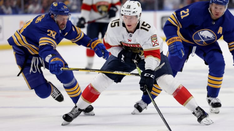 Apr 3, 2022; Buffalo, New York, USA;  Florida Panthers center Anton Lundell (15) skates up ice with the puck as Buffalo Sabres left wing Zemgus Girgensons (28) defends during the first period at KeyBank Center. Mandatory Credit: Timothy T. Ludwig-USA TODAY Sports