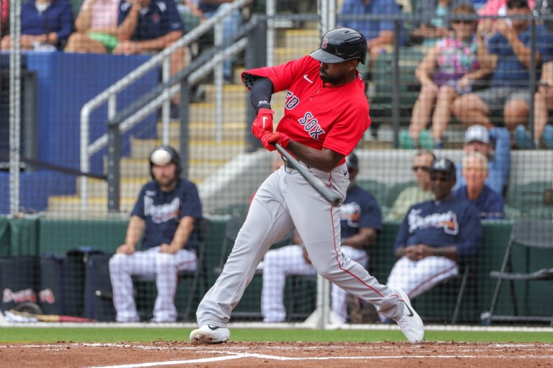 Apr 3, 2022; North Port, Florida, USA; Boston Red Sox center fielder Jackie Bradley Jr. (19) hits a two-run home run during the second inning against the Atlanta Braves during spring training at CoolToday Park. Mandatory Credit: Mike Watters-USA TODAY Sports
