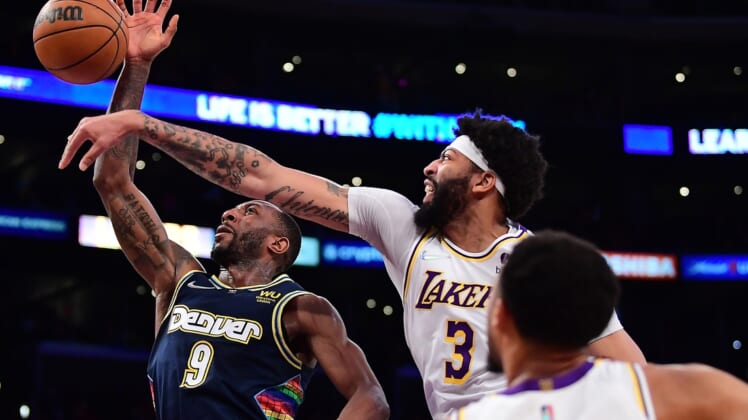 Apr 3, 2022; Los Angeles, California, USA; Los Angeles Lakers forward Anthony Davis (3) blocks the shot of Denver Nuggets guard Davon Reed (9) during the first half at Crypto.com Arena. Mandatory Credit: Gary A. Vasquez-USA TODAY Sports