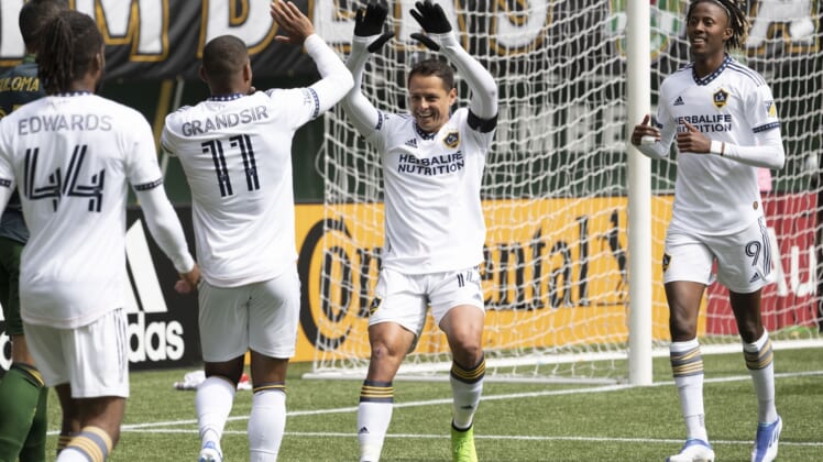 Apr 3, 2022; Portland, Oregon, USA; Los Angeles Galaxy forward Javier Hernandez (14) celebrates with midfielder Samuel Grandsir (11) after scoring a goal during the first half against the Portland Timbers at Providence Park. Mandatory Credit: Troy Wayrynen-USA TODAY Sports