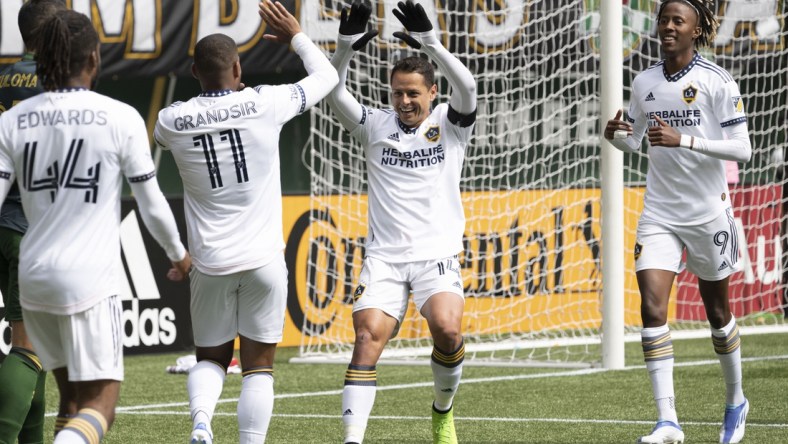 Apr 3, 2022; Portland, Oregon, USA; Los Angeles Galaxy forward Javier Hernandez (14) celebrates with midfielder Samuel Grandsir (11) after scoring a goal during the first half against the Portland Timbers at Providence Park. Mandatory Credit: Troy Wayrynen-USA TODAY Sports