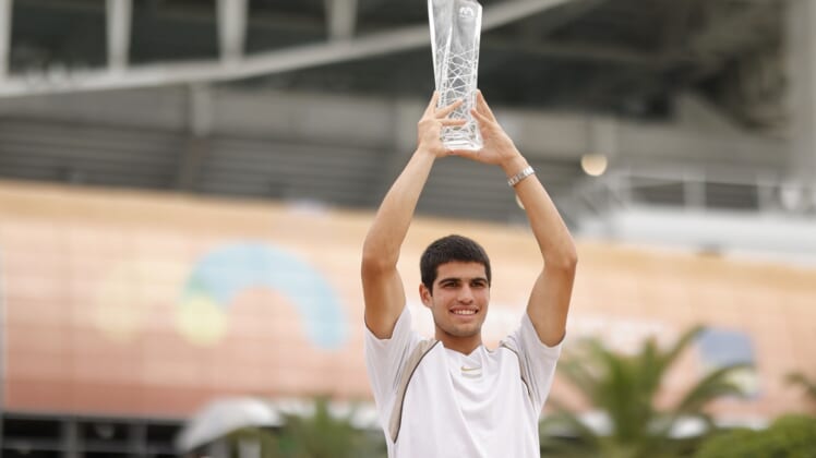 Apr 3, 2022; Miami Gardens, FL, USA; Carlos Alcaraz (ESP) poses for a portrait while holding the Butch Buchholz Championship Trophy after winning the men's singles final in the Miami Open at Hard Rock Stadium. Mandatory Credit: Geoff Burke-USA TODAY Sports