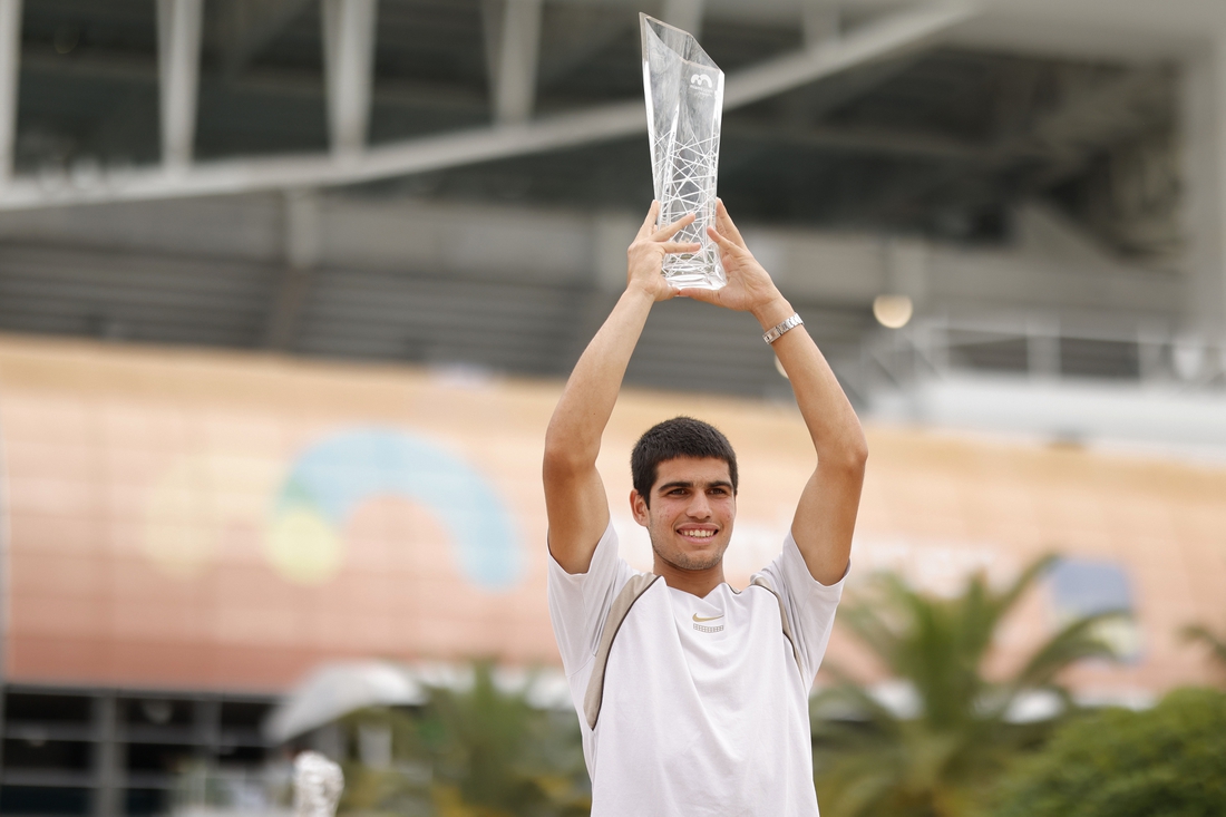 Apr 3, 2022; Miami Gardens, FL, USA; Carlos Alcaraz (ESP) poses for a portrait while holding the Butch Buchholz Championship Trophy after winning the men's singles final in the Miami Open at Hard Rock Stadium. Mandatory Credit: Geoff Burke-USA TODAY Sports