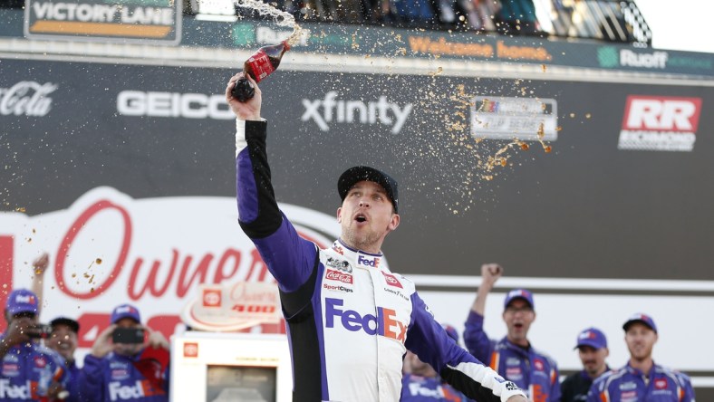 Apr 3, 2022; Richmond, Virginia, USA; NASCAR Cup Series driver Denny Hamlin (11) celebrates in Victory Lane after winning the Toyota Owners 400 at Richmond International Raceway. Mandatory Credit: Amber Searls-USA TODAY Sports