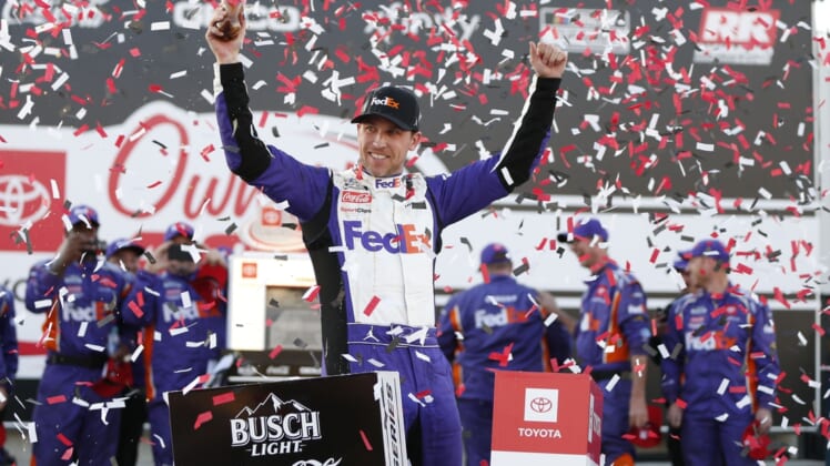 Apr 3, 2022; Richmond, Virginia, USA; NASCAR Cup Series driver Denny Hamlin (11) celebrates in Victory Lane after winning the Toyota Owners 400 at Richmond International Raceway. Mandatory Credit: Amber Searls-USA TODAY Sports