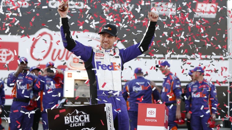 Apr 3, 2022; Richmond, Virginia, USA; NASCAR Cup Series driver Denny Hamlin (11) celebrates in Victory Lane after winning the Toyota Owners 400 at Richmond International Raceway. Mandatory Credit: Amber Searls-USA TODAY Sports