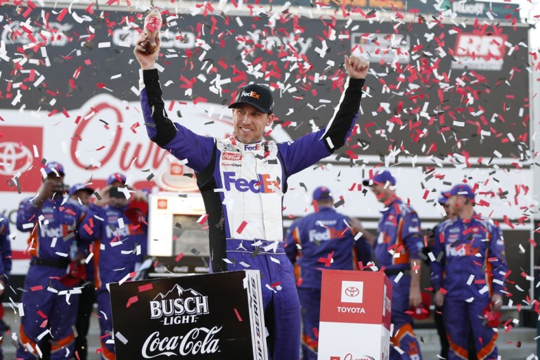 Apr 3, 2022; Richmond, Virginia, USA; NASCAR Cup Series driver Denny Hamlin (11) celebrates in Victory Lane after winning the Toyota Owners 400 at Richmond International Raceway. Mandatory Credit: Amber Searls-USA TODAY Sports