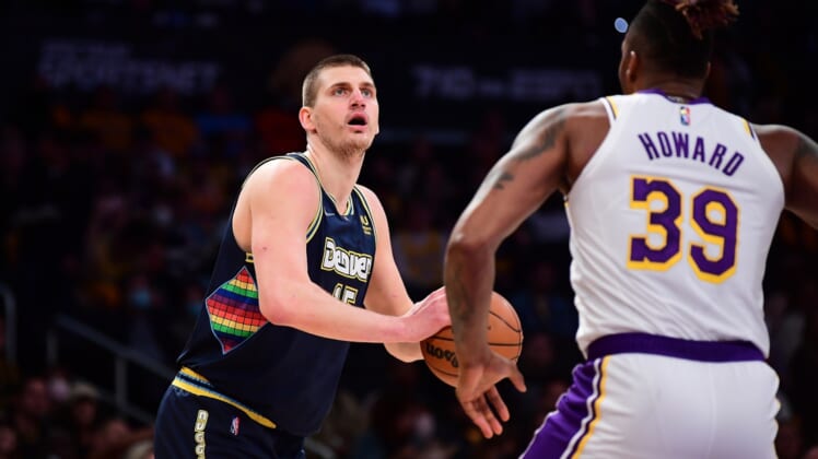 Apr 3, 2022; Los Angeles, California, USA; Denver Nuggets center Nikola Jokic (15) controls the ball against Los Angeles Lakers center Dwight Howard (39) during the first half at Crypto.com Arena. Mandatory Credit: Gary A. Vasquez-USA TODAY Sports
