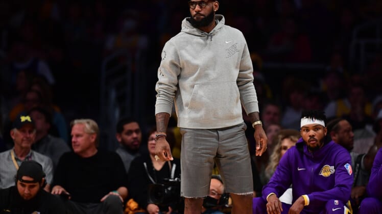 Apr 3, 2022; Los Angeles, California, USA; Los Angeles Lakers forward LeBron James watches game action against the Denver Nuggets during the first half at Crypto.com Arena. Mandatory Credit: Gary A. Vasquez-USA TODAY Sports