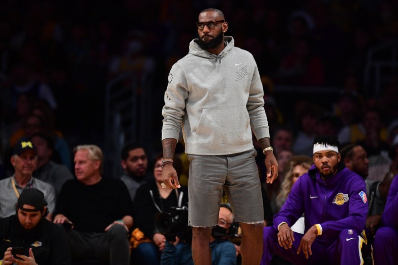 Apr 3, 2022; Los Angeles, California, USA; Los Angeles Lakers forward LeBron James watches game action against the Denver Nuggets during the first half at Crypto.com Arena. Mandatory Credit: Gary A. Vasquez-USA TODAY Sports
