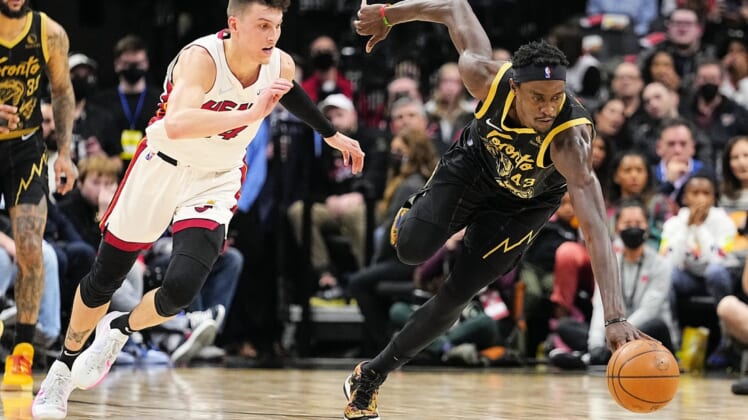 Apr 3, 2022; Toronto, Ontario, CAN; Toronto Raptors forward Pascal Siakam (43) battles for control of the ball as Miami Heat guard Tyler Herro (14) closes in during the first half at Scotiabank Arena. Mandatory Credit: John E. Sokolowski-USA TODAY Sports