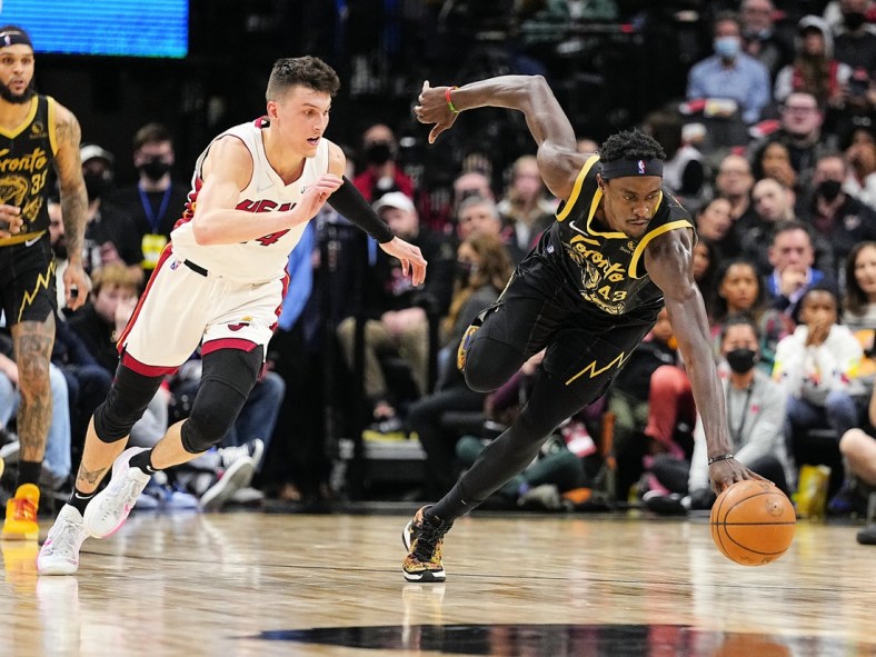 Apr 3, 2022; Toronto, Ontario, CAN; Toronto Raptors forward Pascal Siakam (43) battles for control of the ball as Miami Heat guard Tyler Herro (14) closes in during the first half at Scotiabank Arena. Mandatory Credit: John E. Sokolowski-USA TODAY Sports