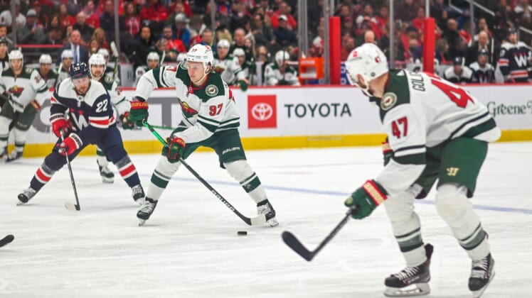 Apr 3, 2022; Washington, District of Columbia, USA;  Minnesota Wild left wing Kirill Kaprizov (97) looks to pass as Washington Capitals left wing Johan Larsson (22) trails during the second period at Capital One Arena. Mandatory Credit: Tommy Gilligan-USA TODAY Sports