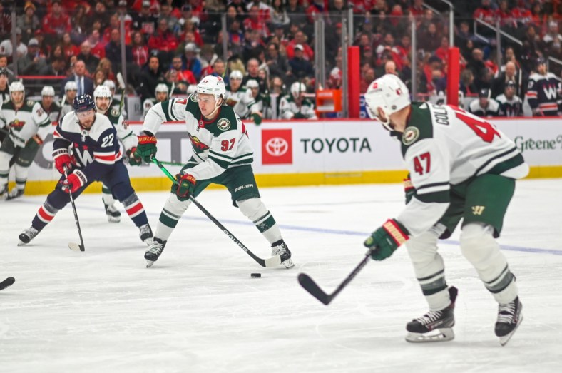 Apr 3, 2022; Washington, District of Columbia, USA;  Minnesota Wild left wing Kirill Kaprizov (97) looks to pass as Washington Capitals left wing Johan Larsson (22) trails during the second period at Capital One Arena. Mandatory Credit: Tommy Gilligan-USA TODAY Sports