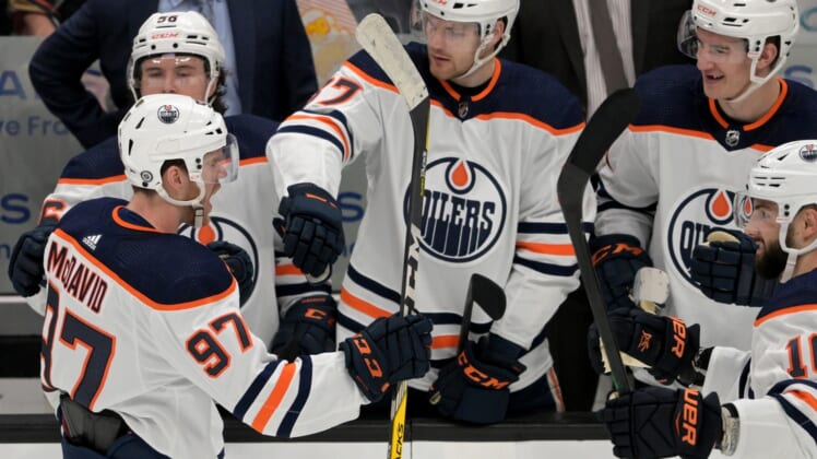 Apr 3, 2022; Anaheim, California, USA; Edmonton Oilers center Connor McDavid (97) is congratulated by the bench after scoring a goal in the first period of the game against the Anaheim Ducks at Honda Center. Mandatory Credit: Jayne Kamin-Oncea-USA TODAY Sports