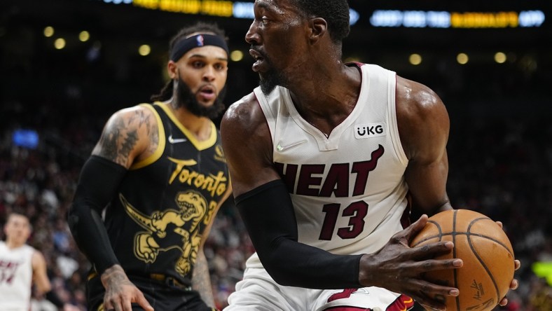 Apr 3, 2022; Toronto, Ontario, CAN; Miami Heat center Bam Adebayo (13) looks to pass the ball as Toronto Raptors guard Gary Trent Jr. (33) defends during the first half at Scotiabank Arena. Mandatory Credit: John E. Sokolowski-USA TODAY Sports