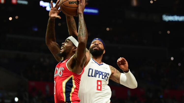Apr 3, 2022; Los Angeles, California, USA; Los Angeles Clippers forward Marcus Morris Sr. (8) blocks the shot of New Orleans Pelicans forward Naji Marshall (8) during the first half at Crypto.com Arena. Mandatory Credit: Gary A. Vasquez-USA TODAY Sports