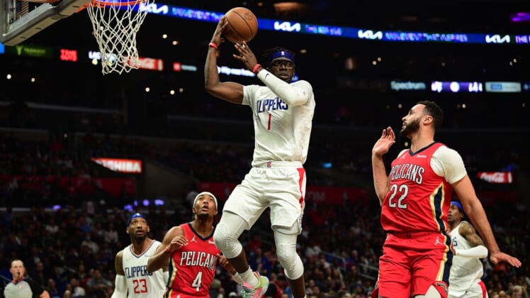 Apr 3, 2022; Los Angeles, California, USA; Los Angeles Clippers guard Reggie Jackson (1) passes the ball against New Orleans Pelicans forward Larry Nance Jr. (22) during the second half at Crypto.com Arena. Mandatory Credit: Gary A. Vasquez-USA TODAY Sports