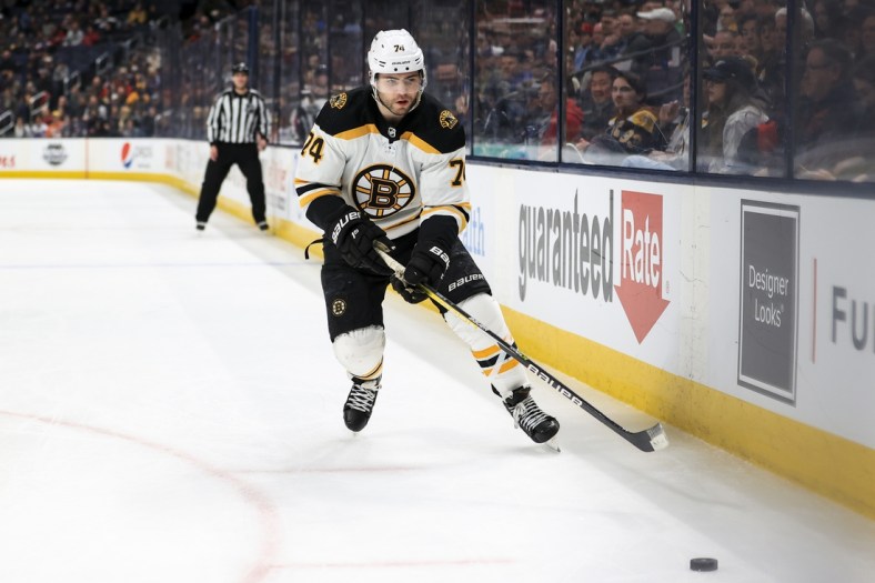 Apr 4, 2022; Columbus, Ohio, USA;  Boston Bruins left wing Jake DeBrusk (74) skates for the puck against the Columbus Blue Jackets in the third period at Nationwide Arena. Mandatory Credit: Aaron Doster-USA TODAY Sports