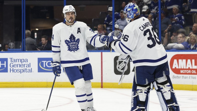 Apr 4, 2022; Tampa, Florida, USA; Toronto Maple Leafs center Auston Matthews (34) is congratulated after he scored a goal against the Tampa Bay Lightning as he scores a hat trick  during the third period at Amalie Arena. Mandatory Credit: Kim Klement-USA TODAY Sports