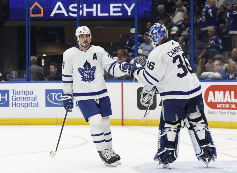 Apr 4, 2022; Tampa, Florida, USA; Toronto Maple Leafs center Auston Matthews (34) is congratulated after he scored a goal against the Tampa Bay Lightning as he scores a hat trick  during the third period at Amalie Arena. Mandatory Credit: Kim Klement-USA TODAY Sports