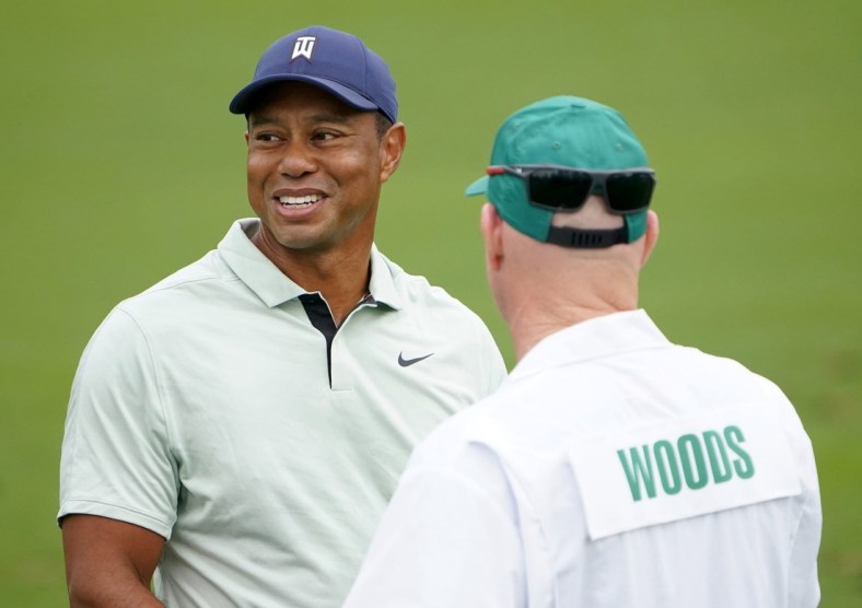 Apr 5, 2022; Augusta, Georgia, USA; Tiger Woods talks with hid caddie, Joe LaCava, while hitting balls at the practice facility during a practice round of The Masters golf tournament at Augusta National Golf Club. Mandatory Credit: Danielle Parhizkaran-Augusta Chronicle/USA TODAY Network

Golf Masters Tournament Practice Round