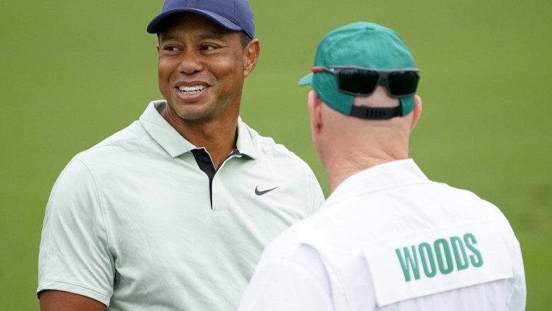 Apr 5, 2022; Augusta, Georgia, USA; Tiger Woods talks with hid caddie, Joe LaCava, while hitting balls at the practice facility during a practice round of The Masters golf tournament at Augusta National Golf Club. Mandatory Credit: Danielle Parhizkaran-Augusta Chronicle/USA TODAY Network

Golf Masters Tournament Practice Round