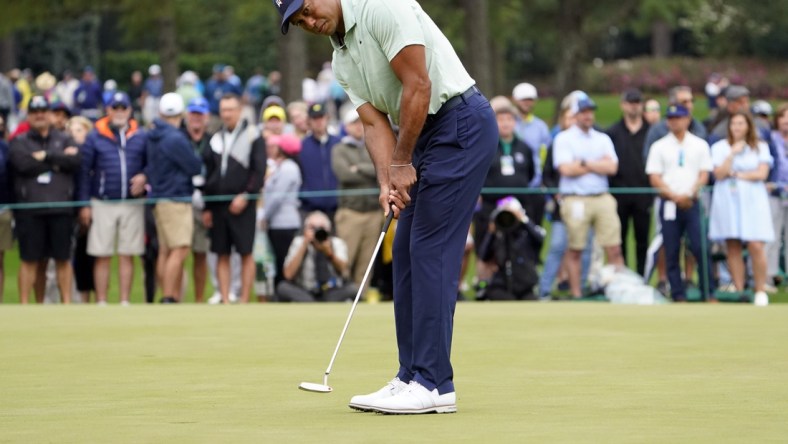 Apr 5, 2022; Augusta, Georgia, USA; Tiger Woods putts on the putting green on the practice range during a practice round of The Masters golf tournament at Augusta National Golf Club. Mandatory Credit: Danielle Parhizkaran-Augusta Chronicle/USA TODAY Network